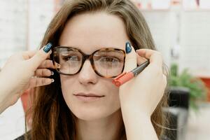 woman trying on glasses