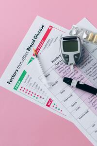 glucose meter on paper explaing what effects blood sugars